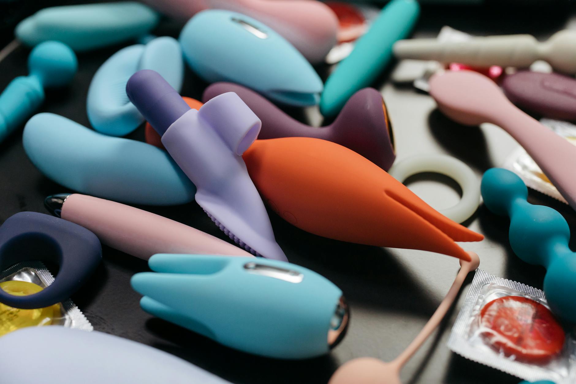 Hands holding a blue personal massager against a textured background