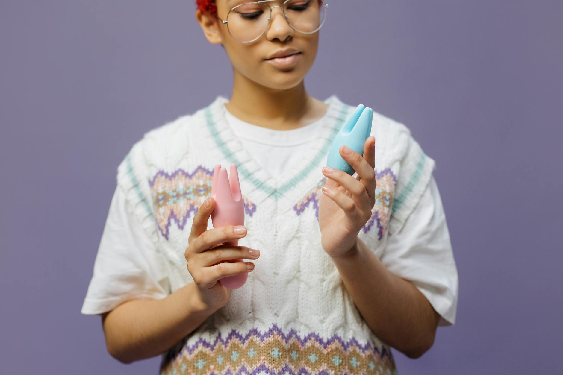 A couple standing together indoors, holding and exploring intimacy with modern devices