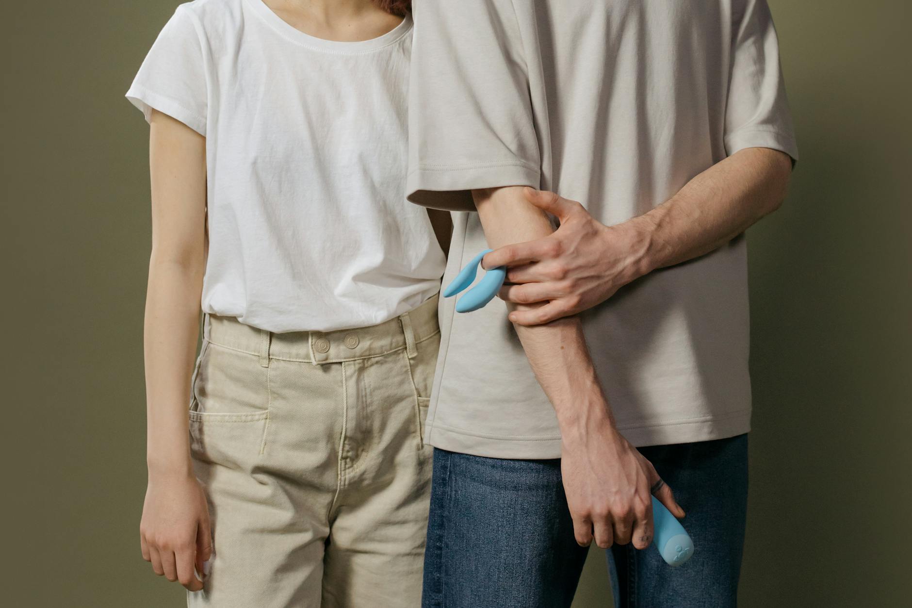A couple standing together indoors, exploring intimacy and modern relationship tools.