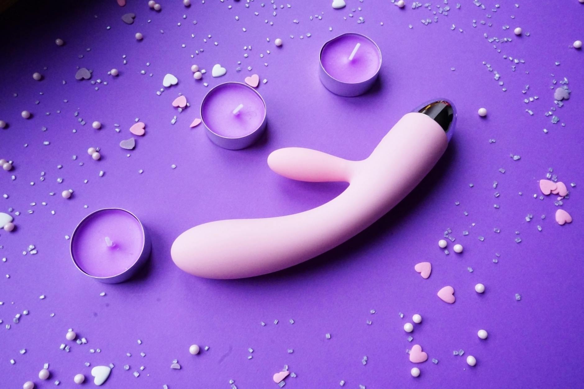 A couple standing together indoors, holding a vibrator, symbolizing modern intimacy and shared pleasure